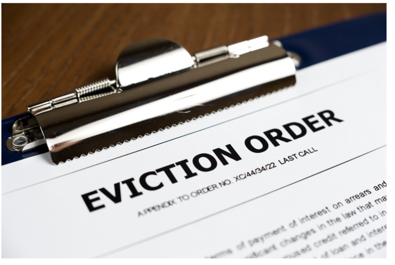 An official eviction order on a clipboard — access withdrawn without warning